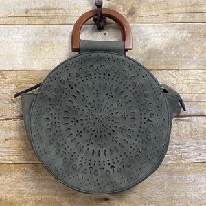 Round olive green handbag with laser cut outs